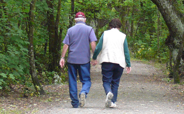 Couple walking on a trail in the woods